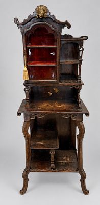 an old wooden cabinet with a red glass door and shelves