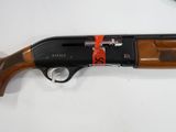 a close up of a shotgun on a white surface