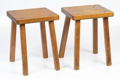 pair of small wooden stools with legs on a white background