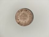 a close up of a coin on a white surface