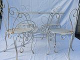 two chairs and a table are sitting on a white cloth