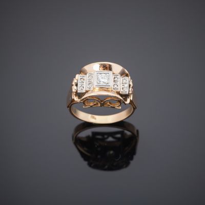 a gold ring with three diamonds on a black surface