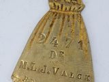an image of a gold medal with the name of a woman