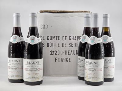 three bottles of red wine sit in front of a box of wine