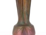 a vase that is sitting on a white surface