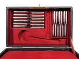 a red case with silverware in it on a white background
