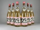 four bottles of gin are lined up in a row on a table