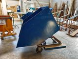 a large blue object on a dolly in a warehouse
