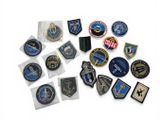 several military patches and badges are arranged on a white surface
