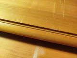a close up of a wooden table with a cat on it