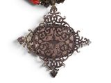 an image of a red necklace with a cross on a white background