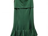 a green dress hanging on a hanger on a white background