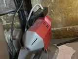 a red and white electric driller sitting on top of a table