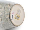 a close up of a vase with a sticker on it