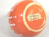 a large orange ball with a sign on it that says heritage power