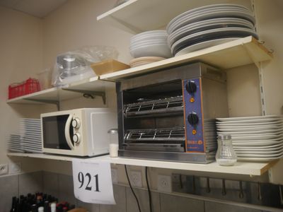 a toaster oven sitting on top of a shelf in a kitchen