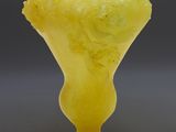 an image of a yellow vase sitting on top of a table