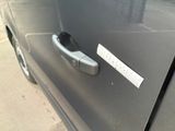 a close up of a car door handle with a sticker on it
