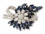 an image of a brooch with blue and white stones
