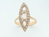 a close up of a gold ring with three diamonds on it