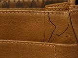 a close up of a wallet with a note inside of it