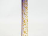 a glass vase that has a purple and yellow design on it