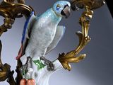 an image of a bird on a branch of a candelab