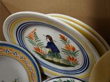 many plates and bowls that are sitting in a box