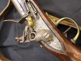 an old gun with a wooden handle on a black background