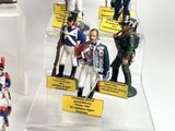 many figurines of soldiers on display in a display case