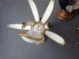 a white and gold object with a face on it