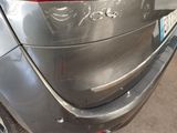 a close up of a car ' s tail end with a sticker on it