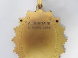 a close up of a medal on a white surface with a white background