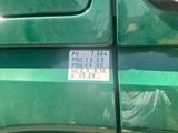 a close up of a green truck with a license plate