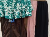 two skirts and a shirt on a rack in a room