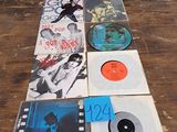 a lot of records sitting on a table in front of a window