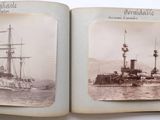 an old photo of a ship in the water and a boat in the water