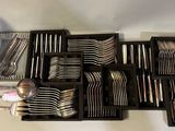 many forks, spoons, and spoons in a black box