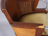 a wooden chair with a yellow seat and a brown back