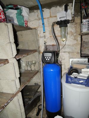 an image of a water softener system in a basement