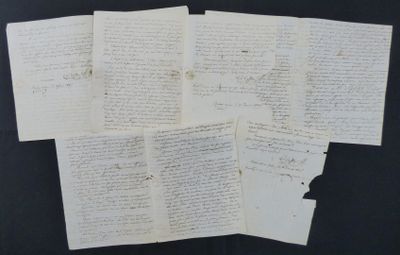 several pieces of old paper with writing on them on a black surface