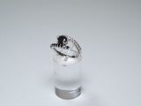 a small glass with a ring on top of it