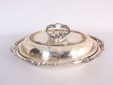 silver plate with a lid on a white surface