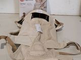 a baby carrier that is sitting on the floor next to a box
