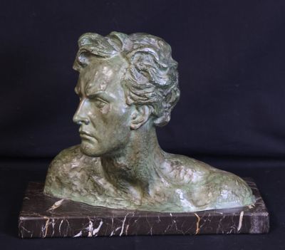 bronze bust of a man on a marble base with a black background