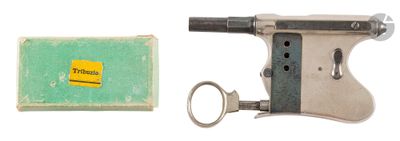 a small gun with a keychain next to a box of soap