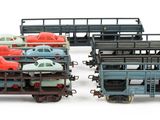 a lot of toy trains that are sitting on a white surface