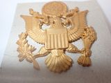 a picture of a gold eagle on a white surface