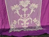 a purple table cloth with white lace on it
