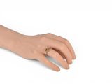 a woman ' s hand with a gold ring on it